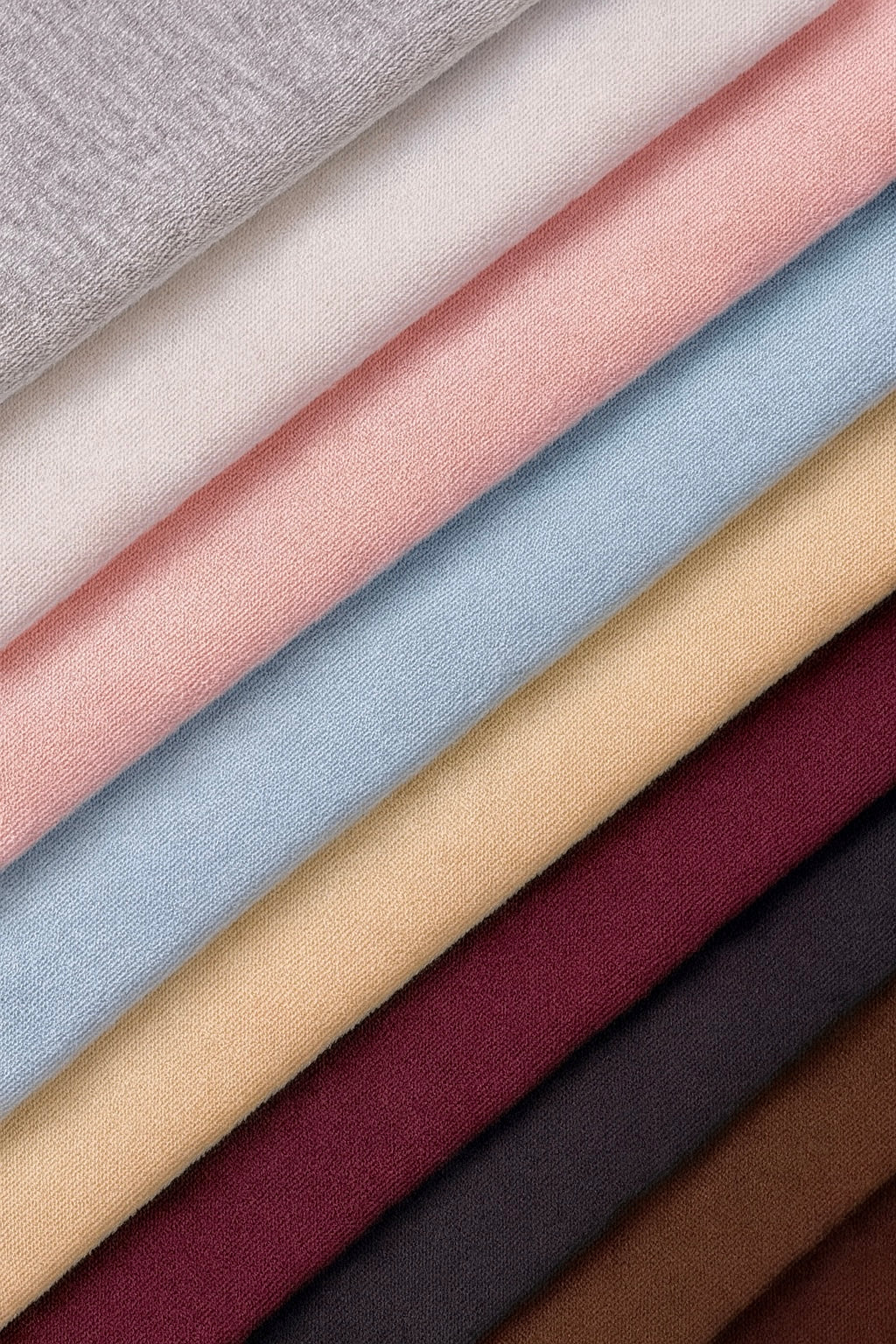 Collection de tissus molleton Cremalier en plusieurs couleurs — gris chiné, blanc, rose, bleu ciel, beige, bordeaux, noir et marron — texture douce et premium.
